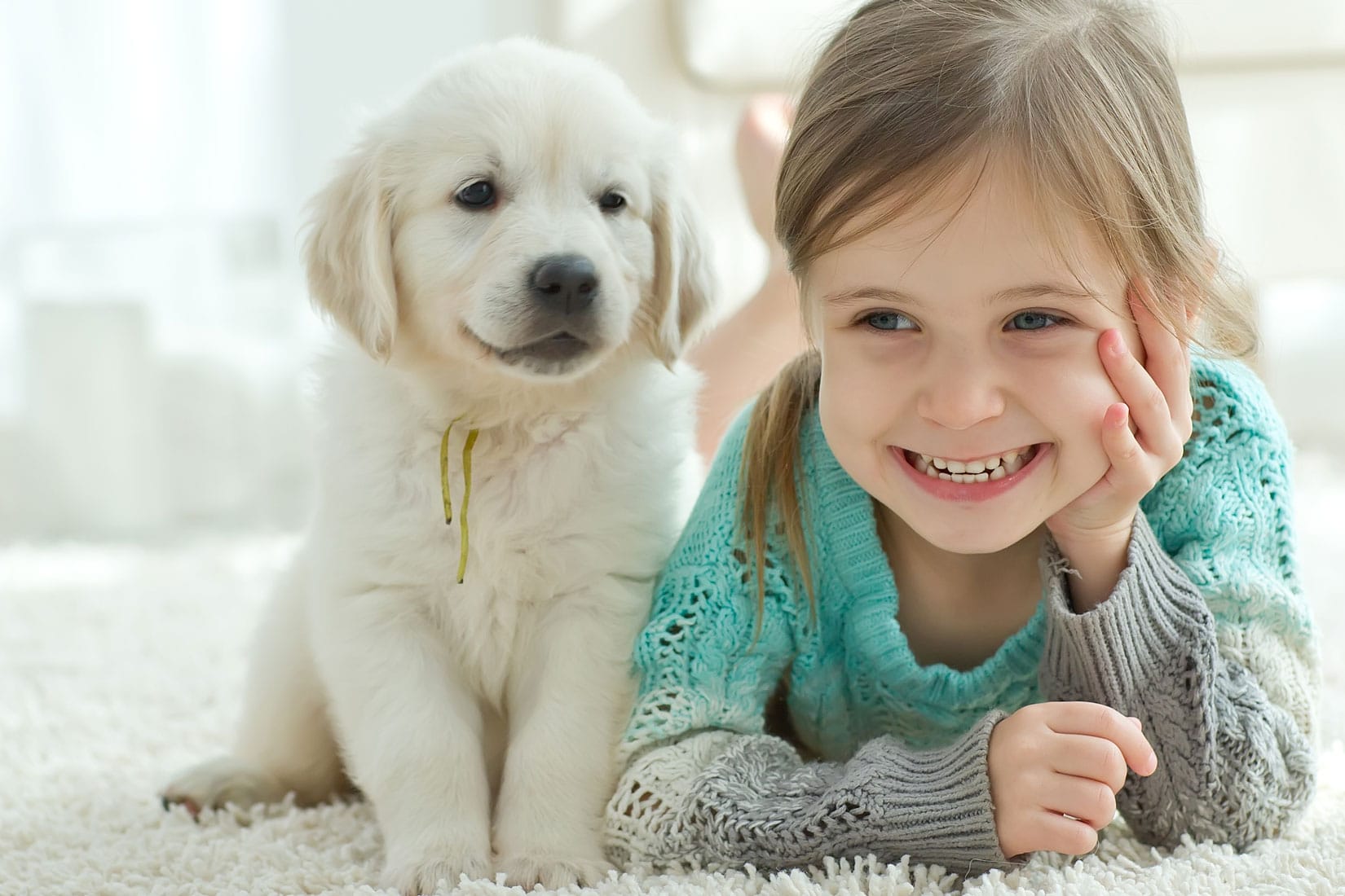 A girl with a dog on the carpet