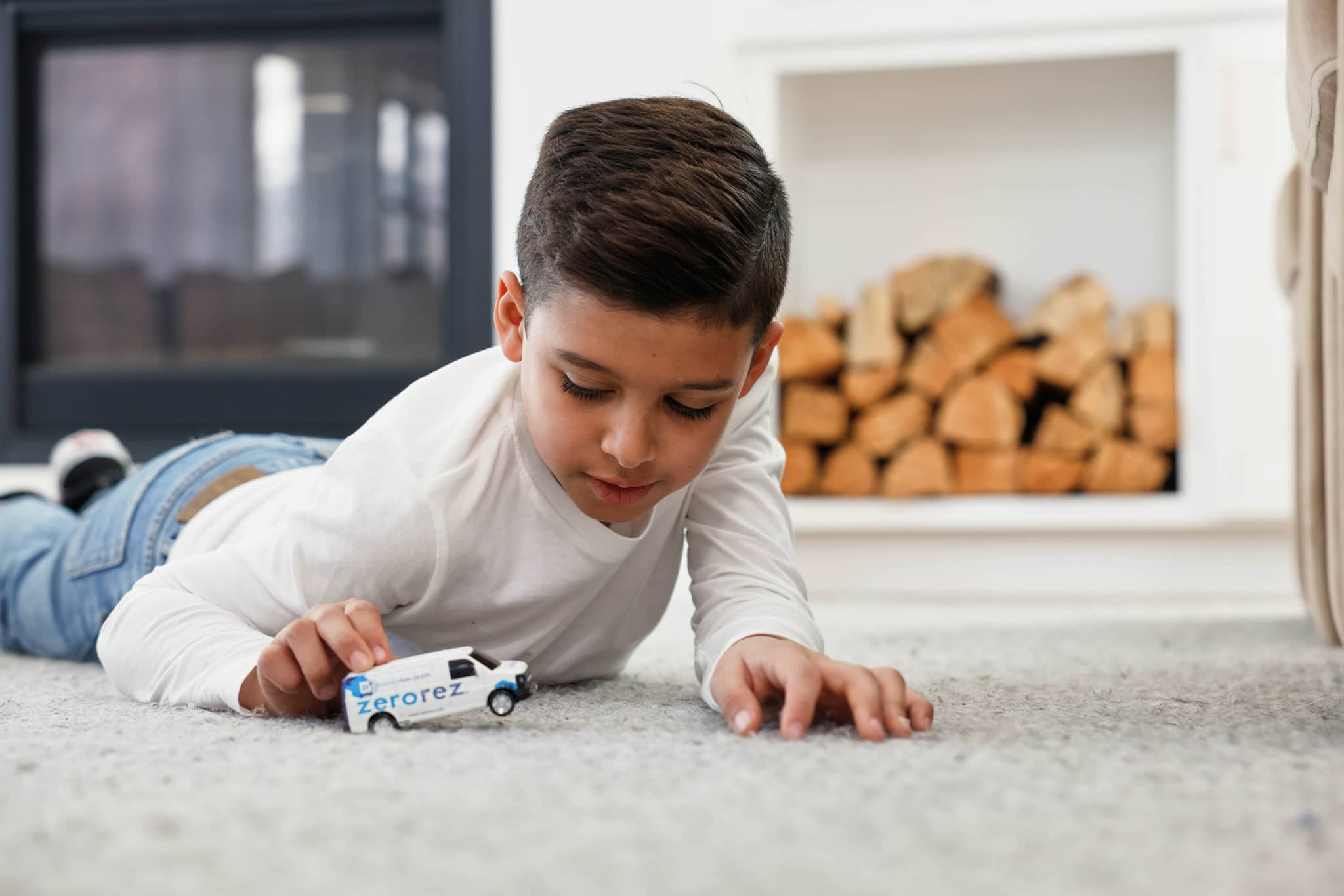 kid playing with a zerorez truck on the carpet